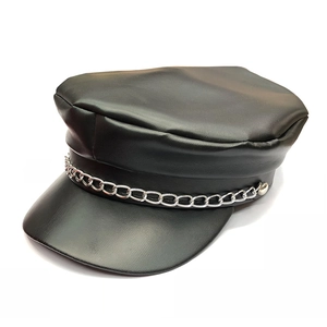Close-up of black leather newsboy cap with silver metal chain detail and smooth texture