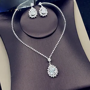 Macro shot of silver bridal jewelry set with pear-cut cubic zirconia and halo accents