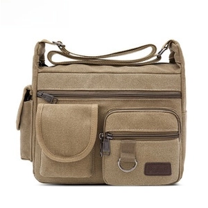 Detail view of the khaki oxford cloth waist bag with multi-pocket and durable zipper design
