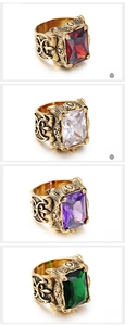 Detail view of vintage gothic rings with fleur-de-lis engravings and colorful gemstones