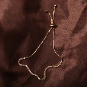 Adjustable gold rhinestone claw chain bracelet with clear zircons on brown silk