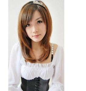 Detail of a black lace-up corset belt styled over a white blouse for a cinched waist look