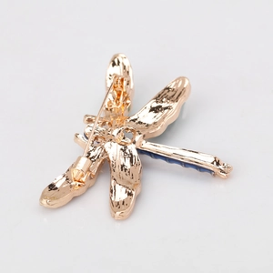 Golden dragonfly brooch with blue enamel body showing a secure pin back clasp design