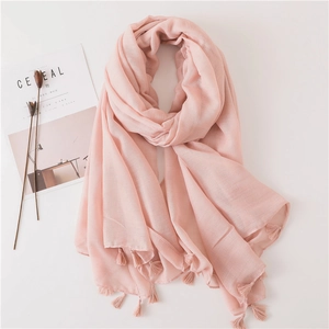 Elegant pale pink linen scarf with delicate fringe trim on a clean white background