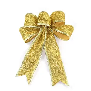 Detail of gold glitter Christmas bow with fine texture and reinforced stitched edges