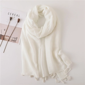 Elegant off-white linen scarf with soft fringe tassels and light natural texture