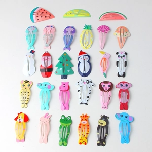 Detailed flat lay of colorful cartoon fruit and animal BB hair clips for children