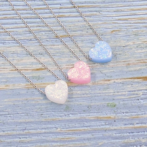 Minimalist heart pendant necklaces with white, pink, and blue opal stones on silver chains