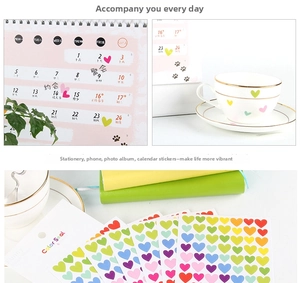Detailed application of colorful heart stickers on a calendar and water bottle