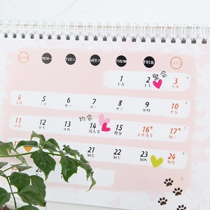 Pink desktop paper calendar with colorful heart stars and lunar holiday markings