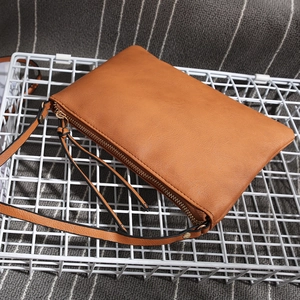 Detailed view of a brown PU leather envelope clutch bag with long fringe tassel zipper