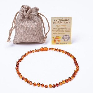 Polished Baltic amber necklace shown with linen pouch and official certificate of authenticity