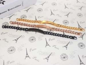 Three minimalist titanium steel bar bracelets in gold, rose gold, and black colors