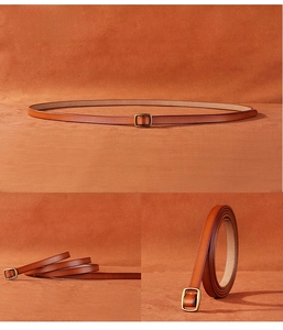 Detail of slim brown leather belt with vintage bronze square buckle for dresses