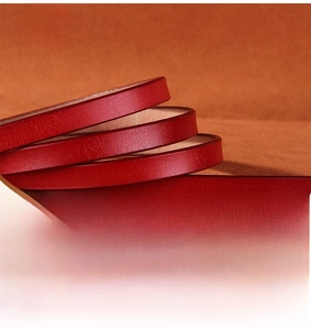 Macro shot of durable red cowhide leather belt showing natural texture and solid structure