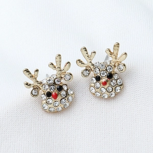 Sparkling gold reindeer Christmas stud earrings with white rhinestones on knit fabric