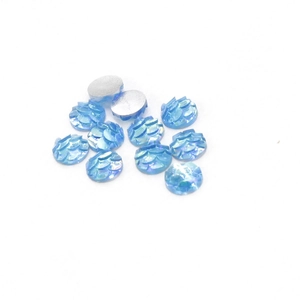 Macro shot of 6mm blue fish scale resin cabochons with iridescent AB rainbow finish