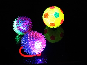Glow-in-the-dark spiky massage balls with internal LED lights and soft rubber texture
