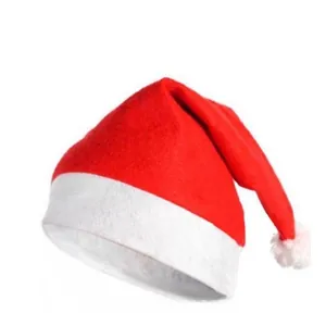 Close-up of classic red non-woven Christmas hat with plush white trim and fluffy pompom