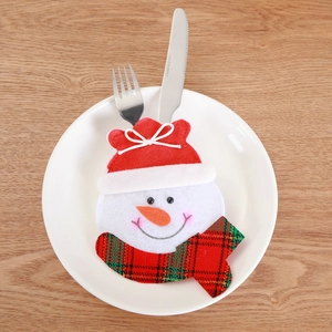 Christmas snowman cutlery holder on white plate with festive red scarf and fork set
