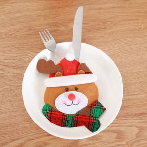 Christmas reindeer cutlery holder pouch on white plate with silver flatware set