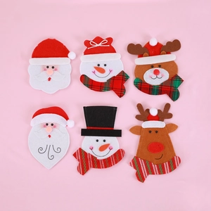 Close-up of Santa, Snowman, and Reindeer felt cutlery holders for Christmas table decor