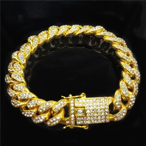 Macro detail of 18K gold Cuban link bracelet with full pave diamond setting and clasp