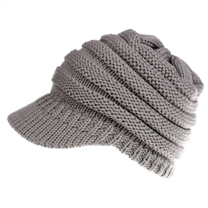 Detail of grey knitted baseball cap showing thick texture and ribbed wool pattern