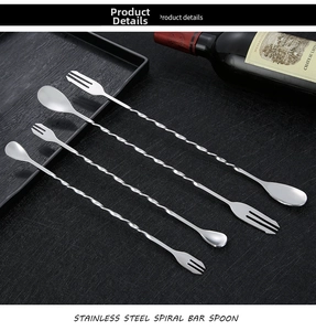 Macro view of four double-ended stainless steel cocktail mixing spoons with spiral handles