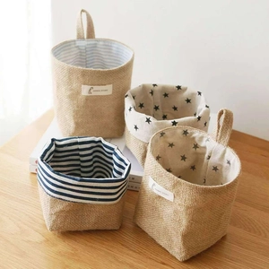 Mini jute storage baskets with striped and star patterns on a warm wooden tabletop