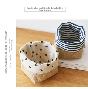 Detail view of cotton linen storage bags featuring black stars and blue stripes patterns