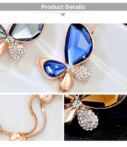 Macro details of butterfly crystal pendant with blue stones and rose gold snake chain