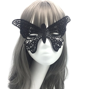 Close-up of black lace butterfly mask with intricate hollow patterns on a model's face