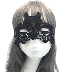 Close-up of intricate black lace mask with hollow butterfly pattern on a mannequin head