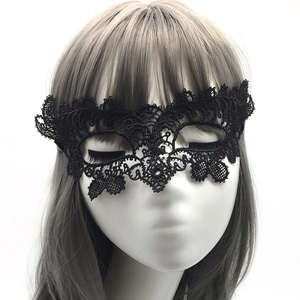Close-up of elegant black lace eye mask with intricate floral pattern for party