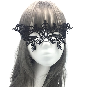 Close-up of elegant black lace masquerade mask with intricate hollow patterns on a model