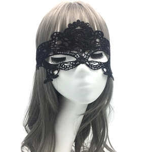 Close-up of black lace masquerade eye mask with intricate floral cutout patterns