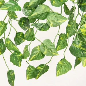 Close-up of artificial ivy leaves with yellow-green marble texture for wall decoration