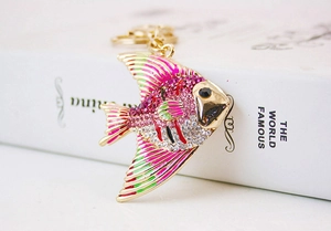 Close-up of tropical fish keychain with colorful rhinestones and gold metal chain