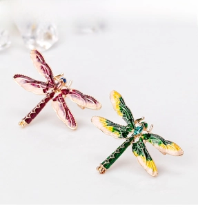 Close-up of vintage dragonfly brooch with enamel wings and sparkling crystal rhinestones