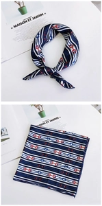 Detail of square silk scarf with navy blue stripes and red horsebit pattern