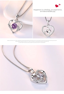 Detail of S925 sterling silver heart necklace featuring a rotating purple gemstone center