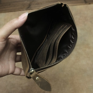 Interior detail of vintage brown leather wallet showing multiple card slots and zipper pocket