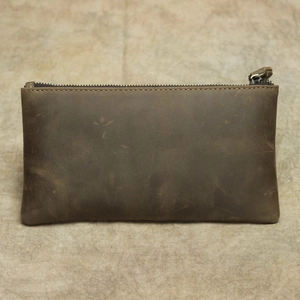 Close-up of vintage brown crazy horse leather wallet featuring a durable metal zipper