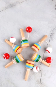 Top-down view of six wooden kendama skill cup toys arranged in a circular radial layout