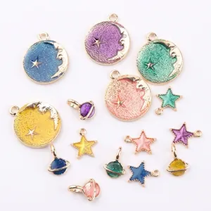 Detail of 18K gold-plated celestial charms including crescent moons and star planets