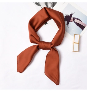 Close-up of caramel silk square scarf with high-gloss finish for neck or bag decoration