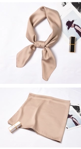 Detail of satin square scarf showing silk texture with champagne gold drape and knots