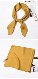 Detailed view of ginger yellow satin square scarf with silky texture and neat hem stitching
