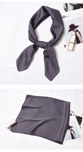 Close-up of knotted and folded gray silk satin square scarf with professional style
